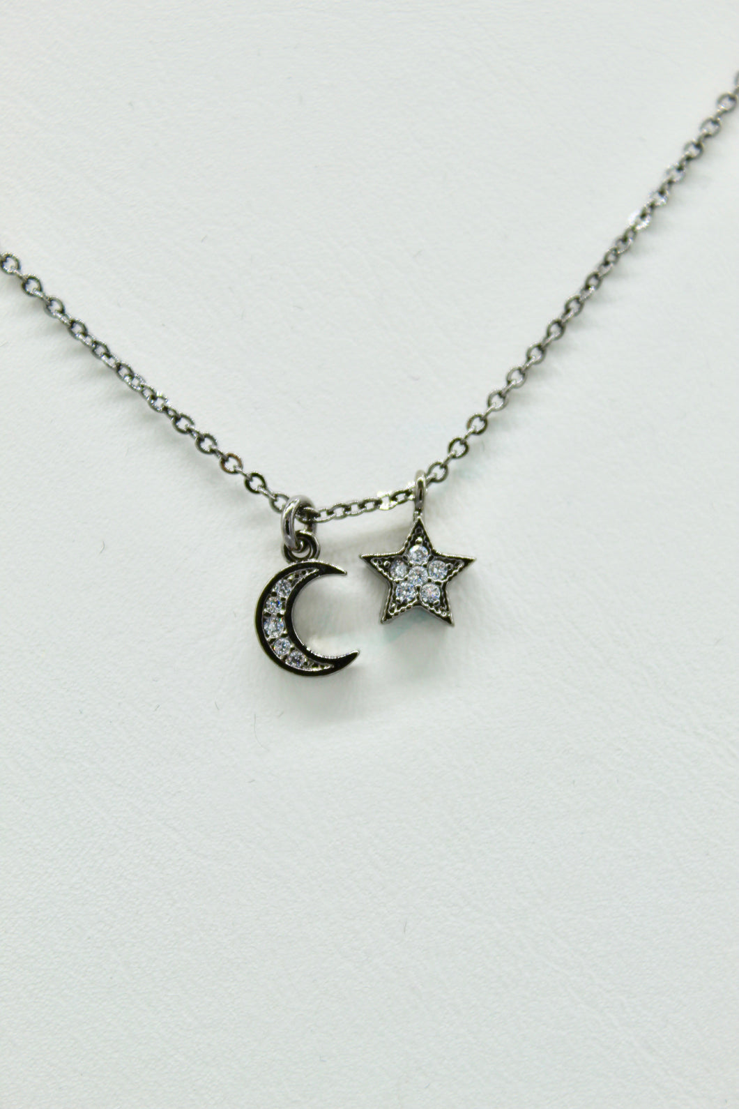 Hematite colored chain necklace w/pave CZ moon and solid star charms