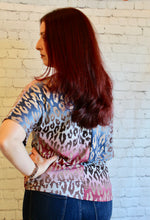Load image into Gallery viewer, One shoulder cheetah knit top featuring dolman sleeves and self tie knot