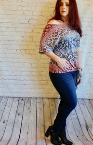 One shoulder cheetah knit top featuring dolman sleeves and self tie knot